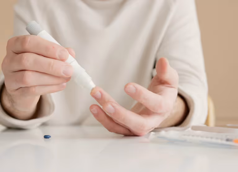 Person checking their glucose levels with finger prick method