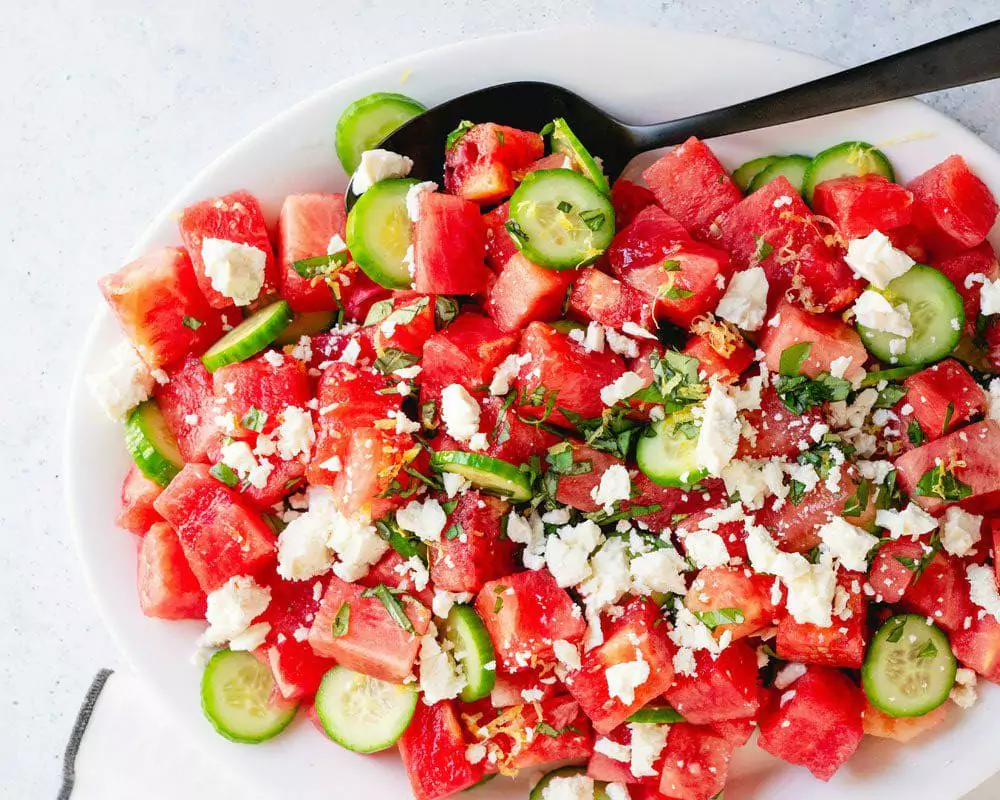 a plate of watermelon cucumber salad
