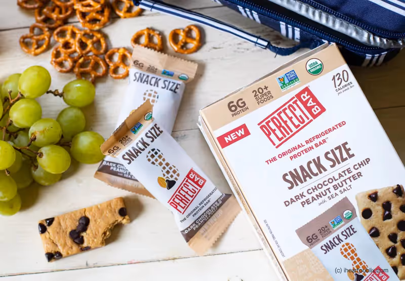 Perfect snack size bars surrounded by grapes and pretzels