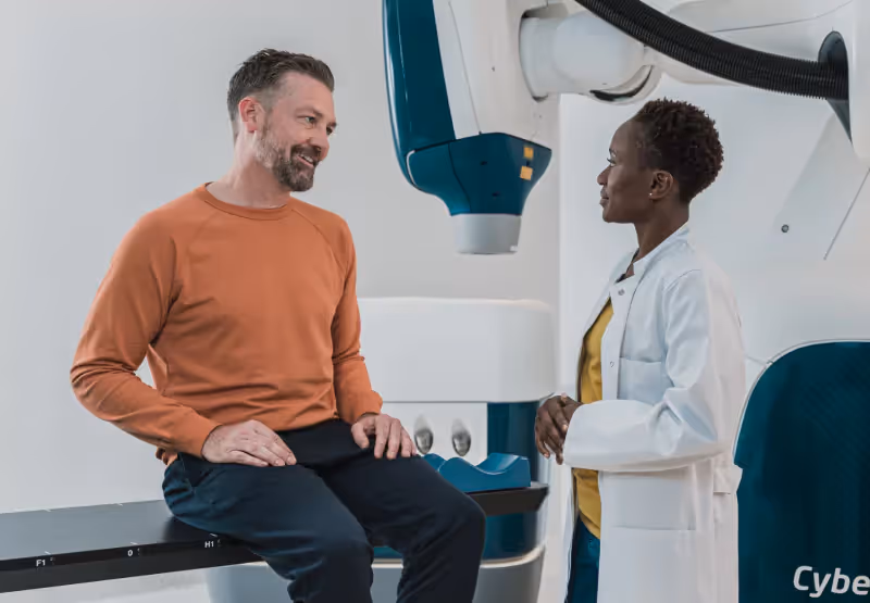 a man at the doctor's office sitting on a table