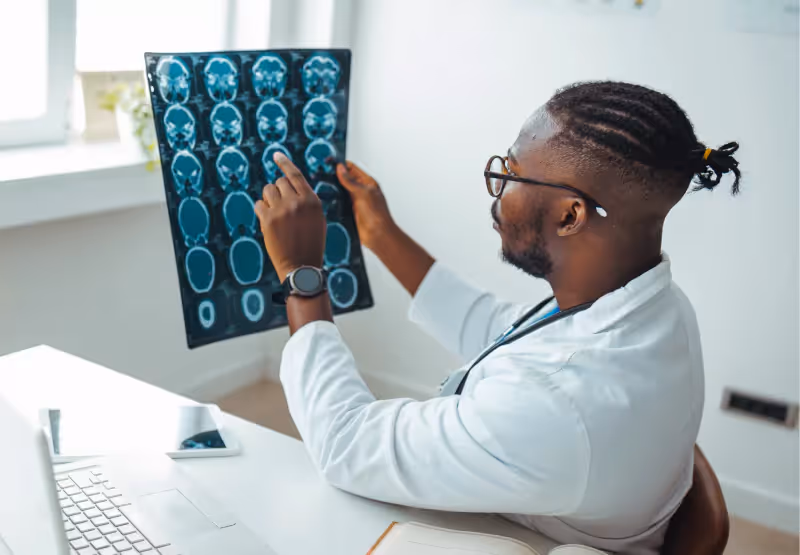 a doctor looking at brain scans