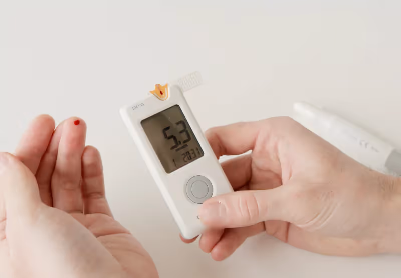 someone checking their blood sugar with a glucometer