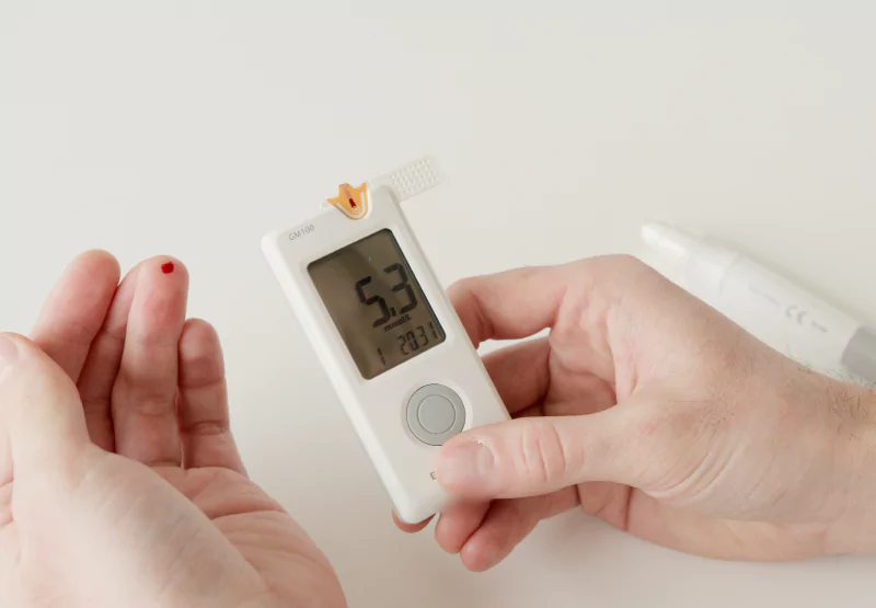 someone checking their blood sugar with a glucometer