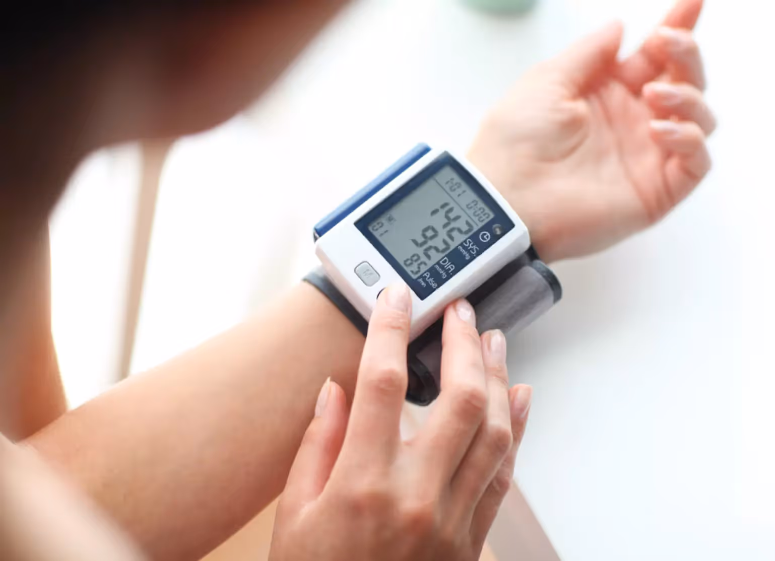 Person measuring their blood pressure