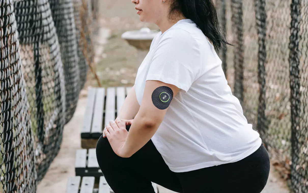 a person wearing Nutrisense CGM and working out 