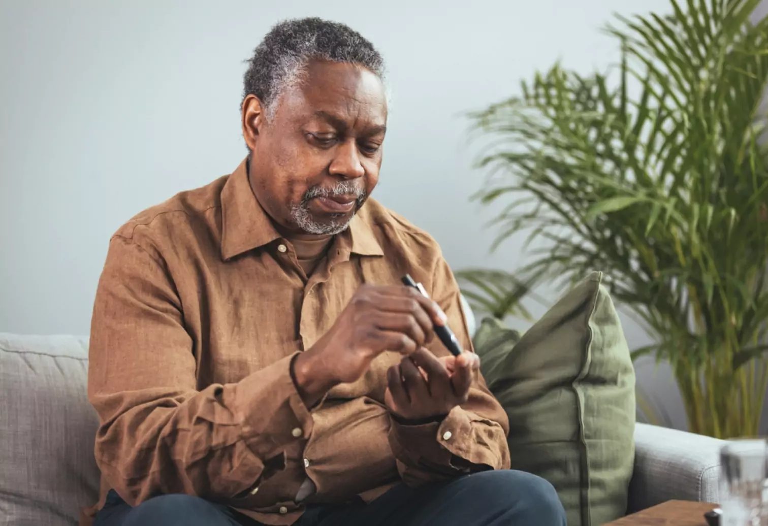 a person using finger prick method to test their glucose level