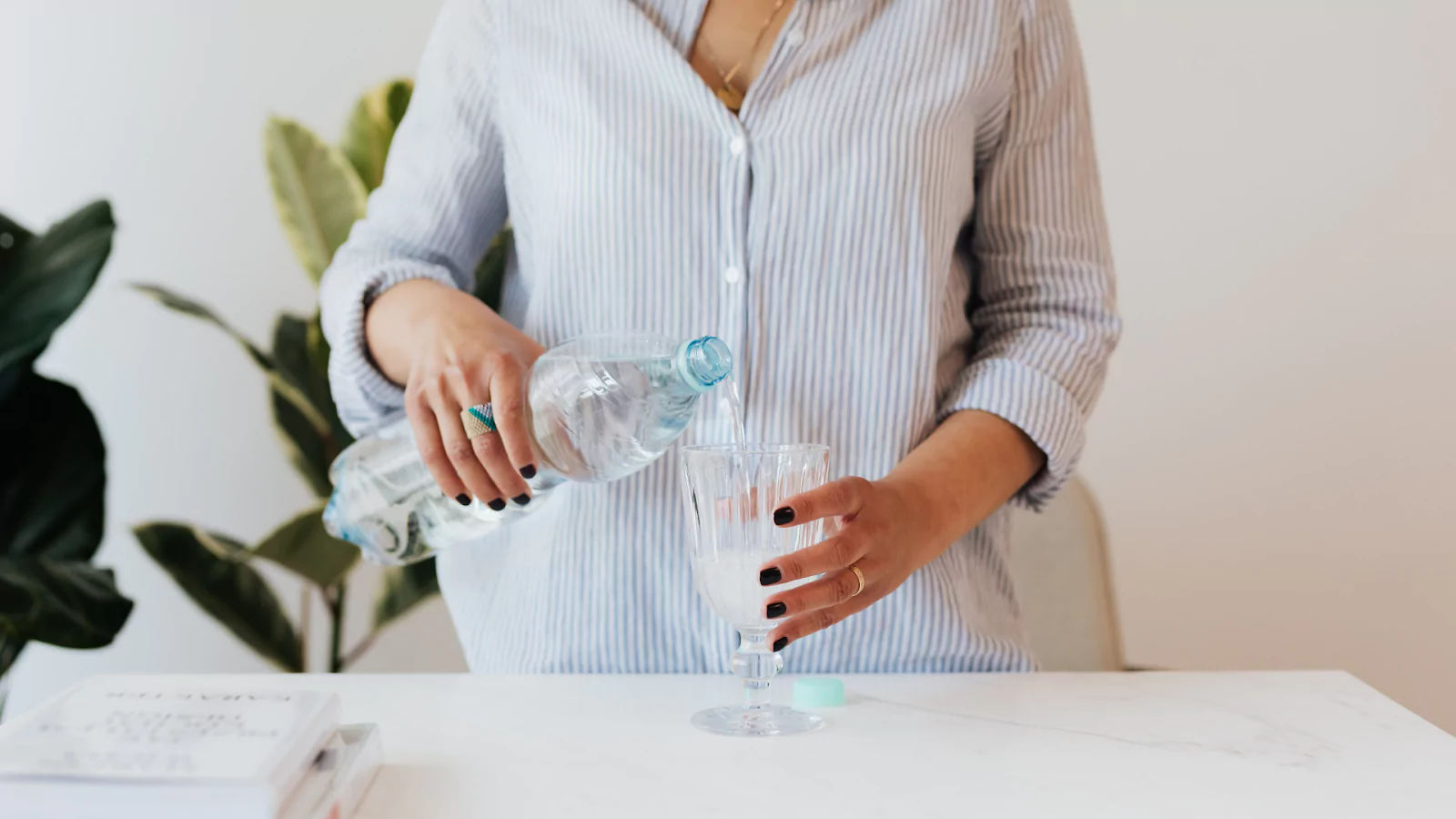 woman pouring water into glass