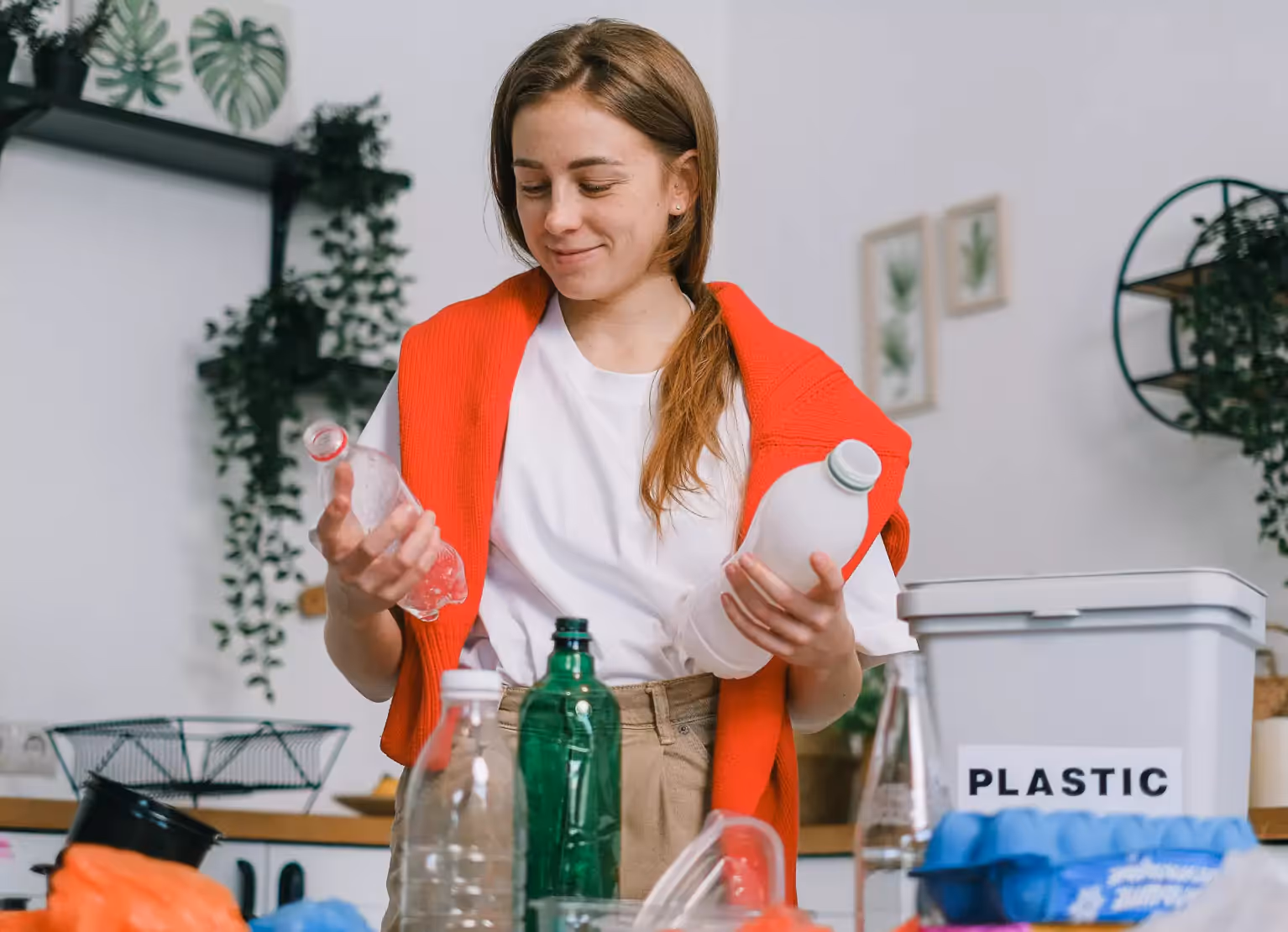 Woman throwing away plastic bottles