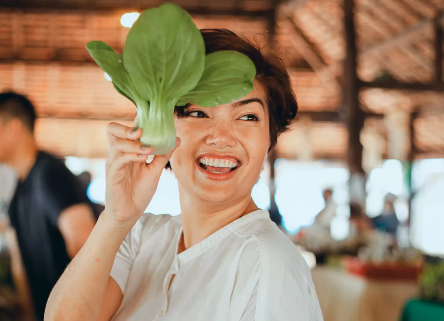 Woman holding up organic leafy greens