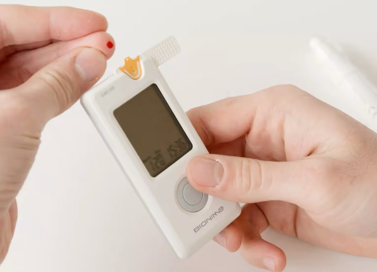 Person pricking their finger for blood glucose testing