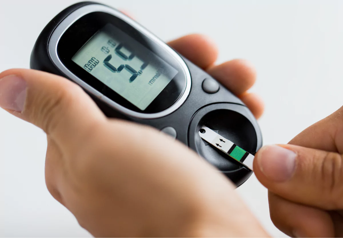 someone monitoring their blood sugar with a bgm