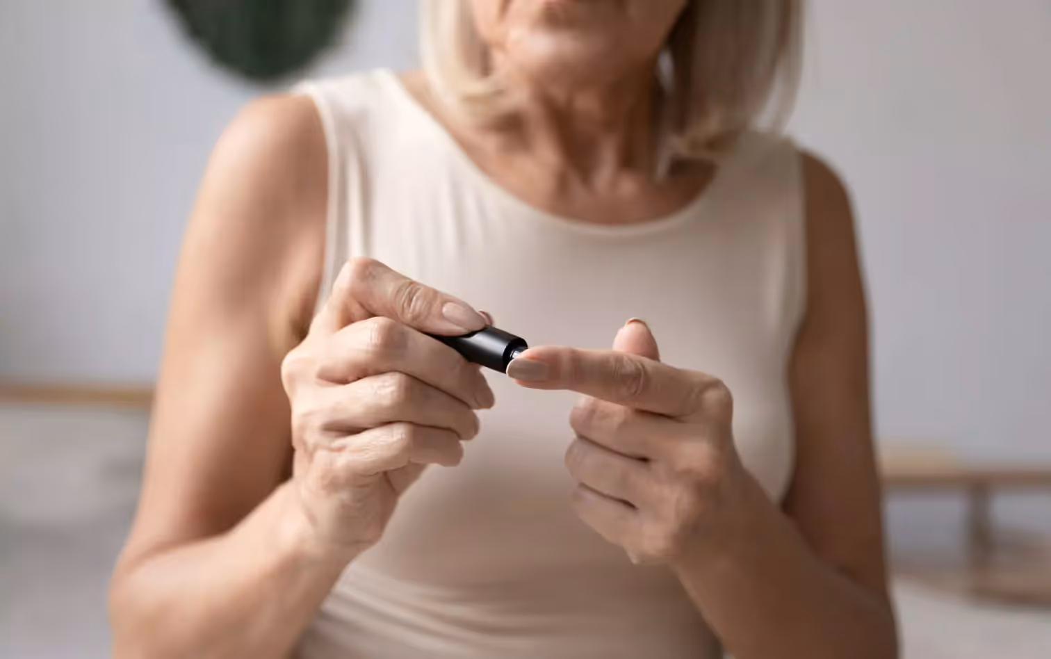 an older person checking their level of blood glucose