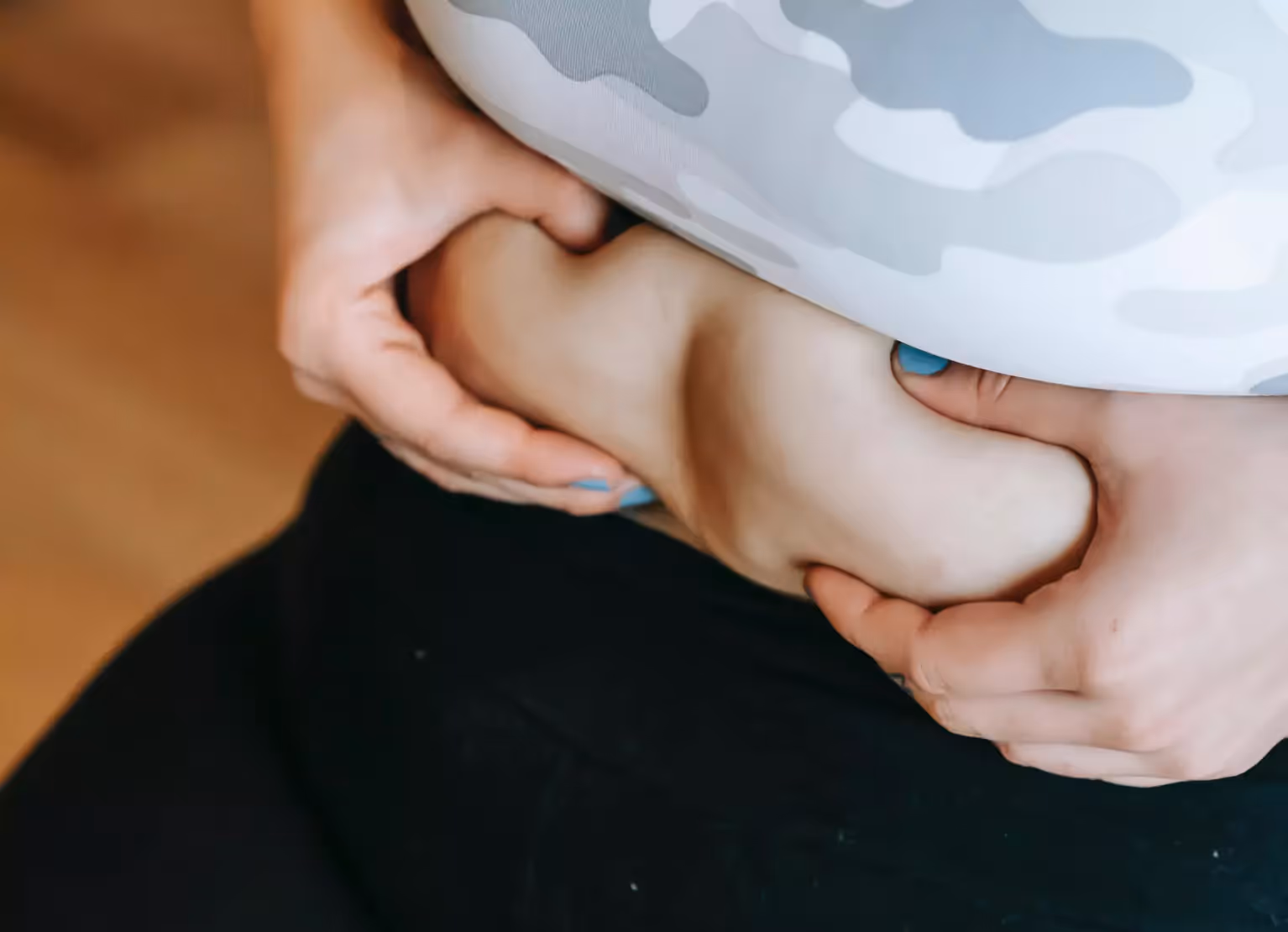 A person squeezing their stomach