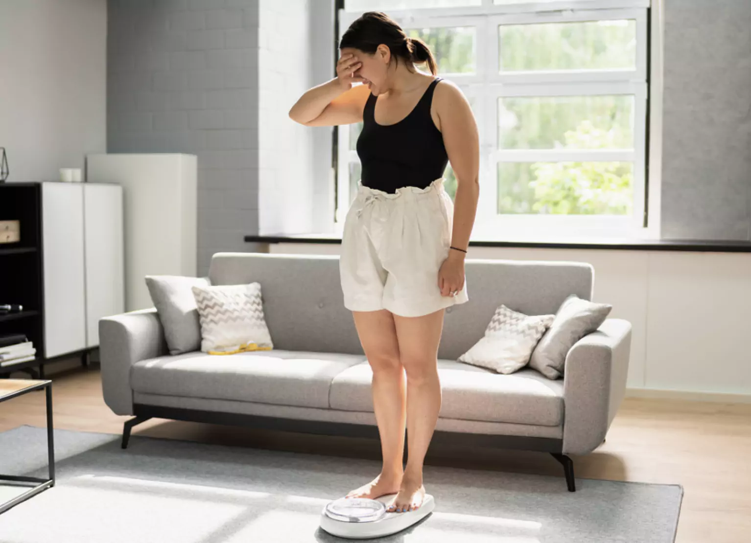 A person looking frustrated on the scale