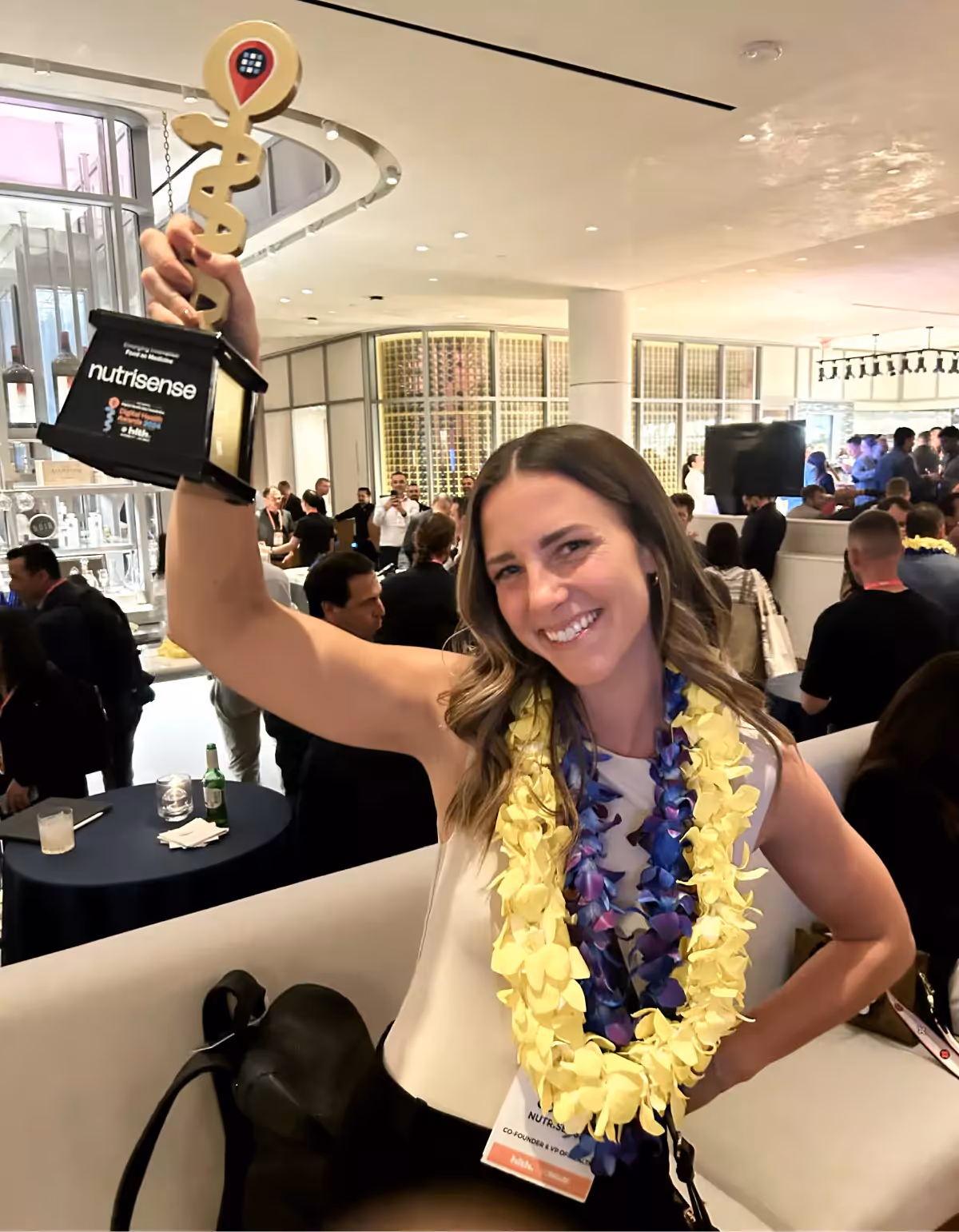 Kara Collier at HLTH USA with her award