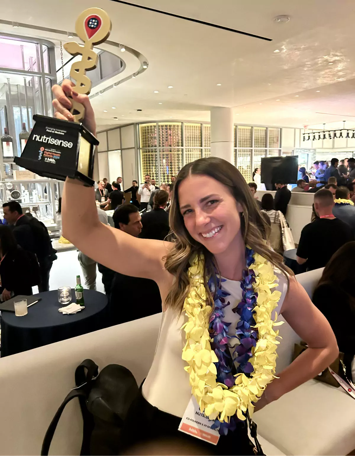 Kara Collier at HLTH USA with her award