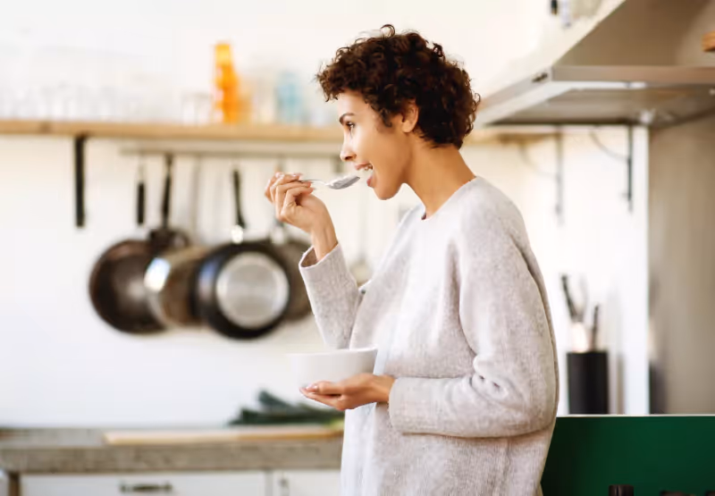 someone eating a spoonful of food