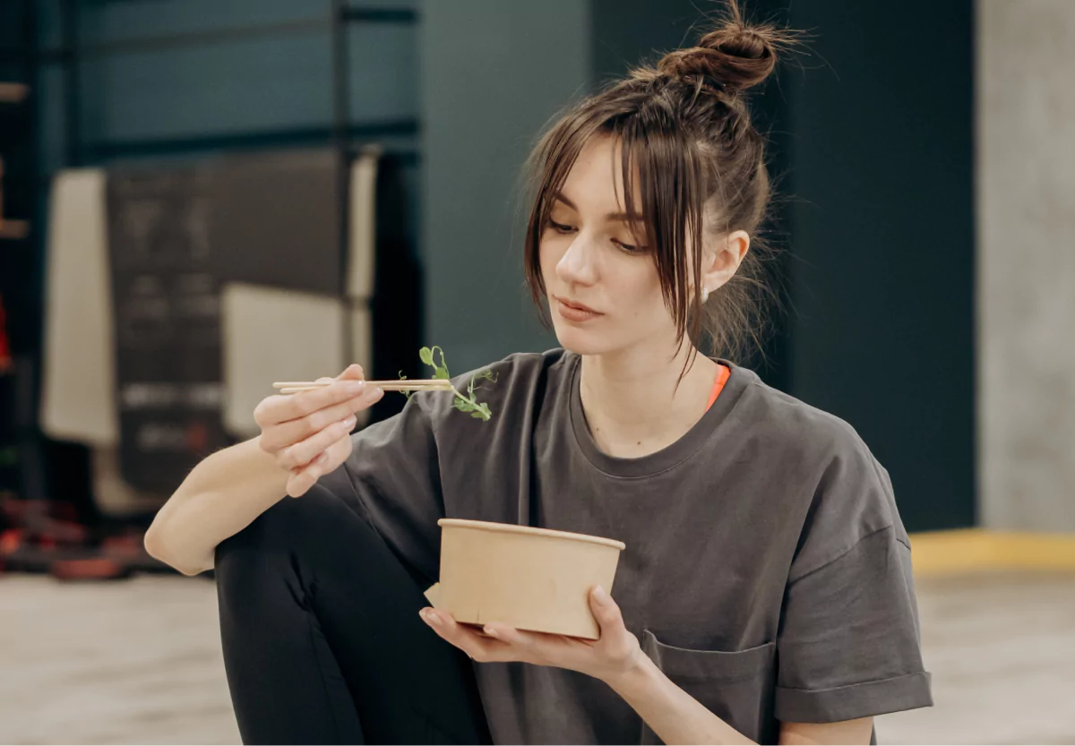a girl eating a salad