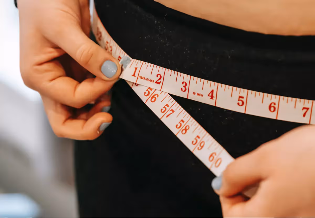 someone measuring their waist