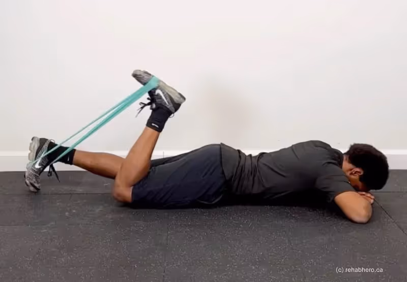 Person doing hamstring curls on yoga mat