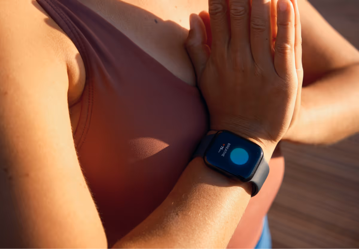 Closeup of person in workout gear with hands in meditative pose
