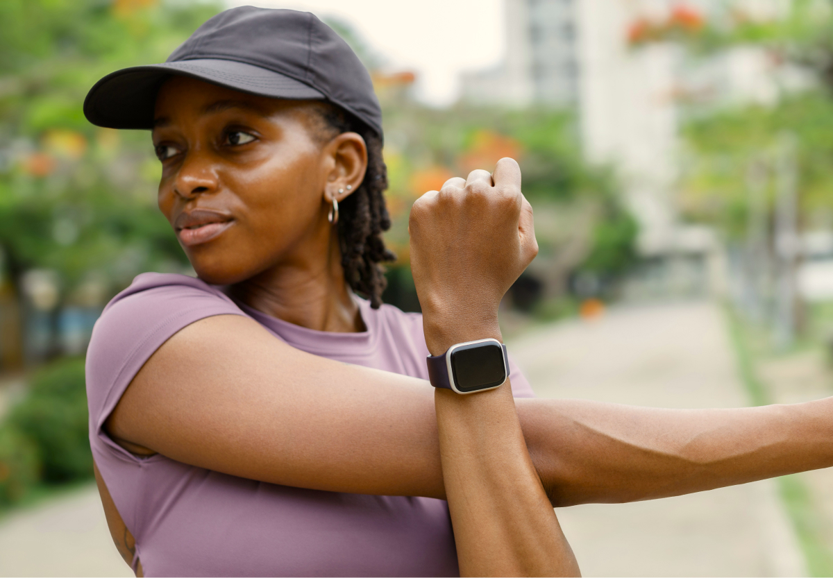 Person in workout gear stretching as they prepare to workout outdoors