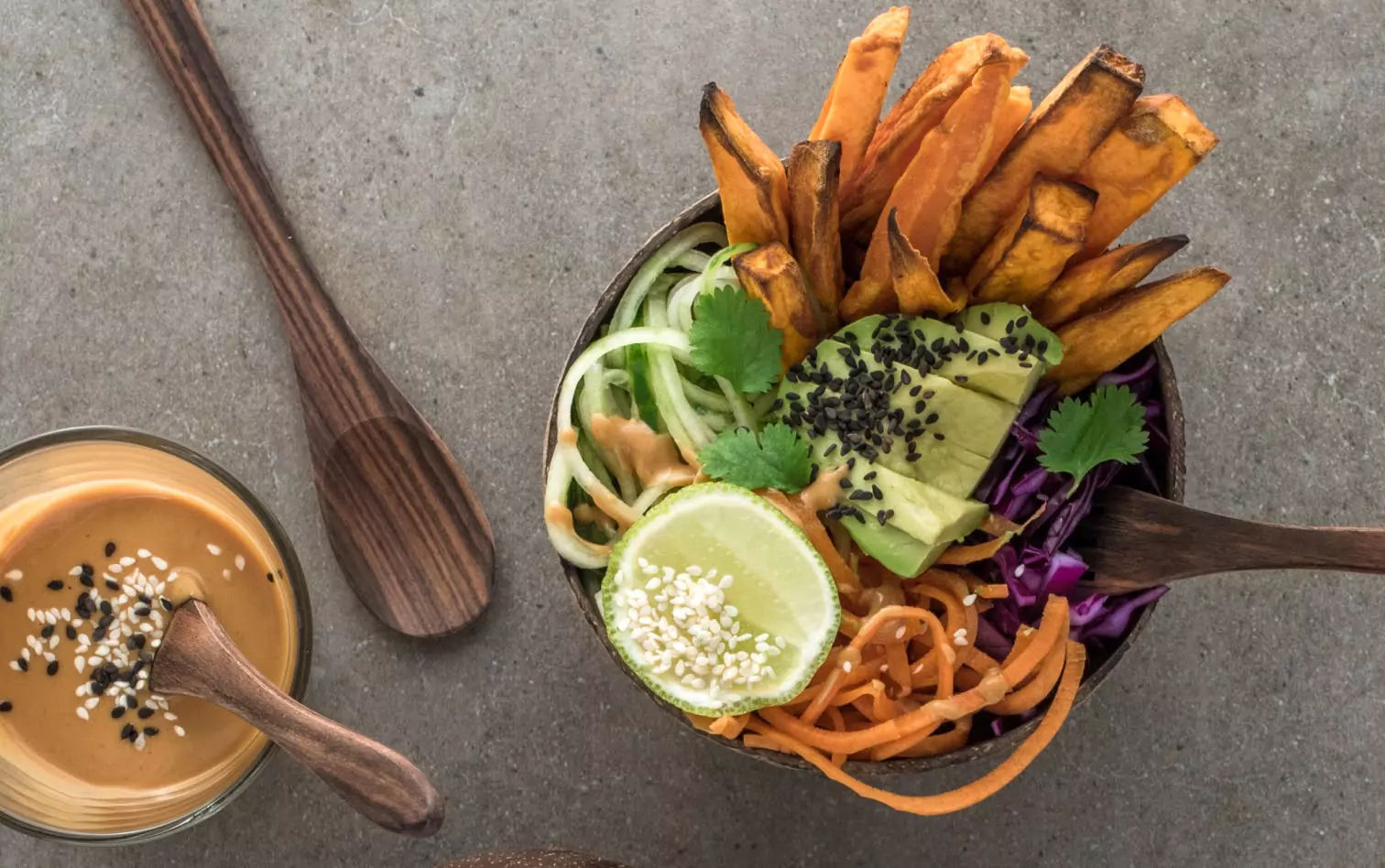 a bowl of sweet potatoes, an avocado and veggies
