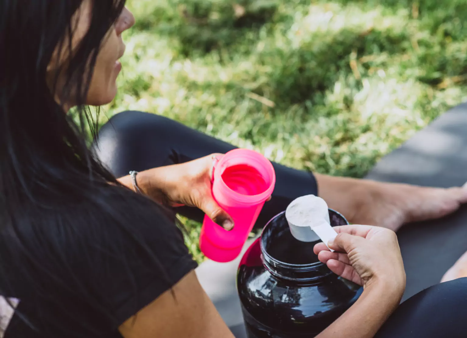 a person putting BCAA powder into a water bottle