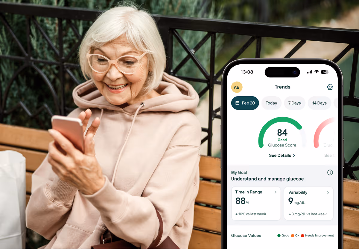 An older person in glasses and pink sweatshirt outdoors, looking at a mobile phone, along with an image of the Nutrisense app screen overlaid on top on the right