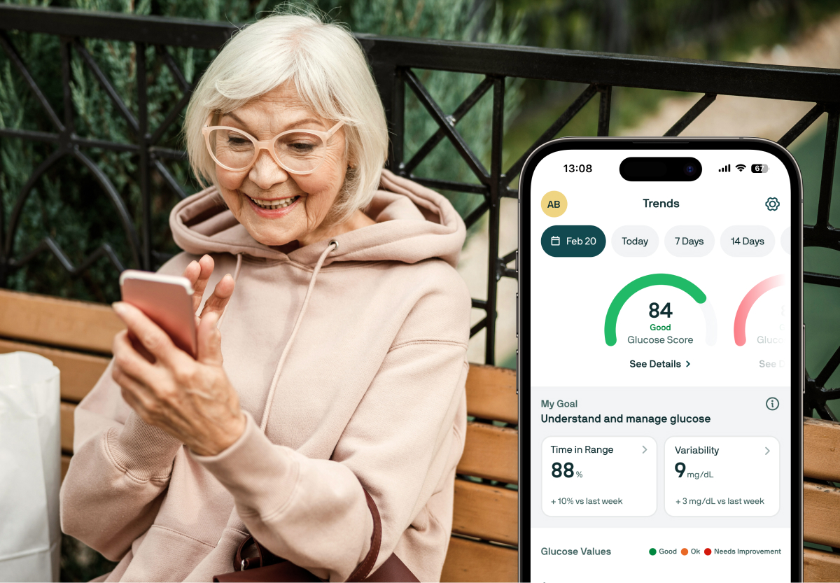 An older person in glasses and pink sweatshirt outdoors, looking at a mobile phone, along with an image of the Nutrisense app screen overlaid on top on the right