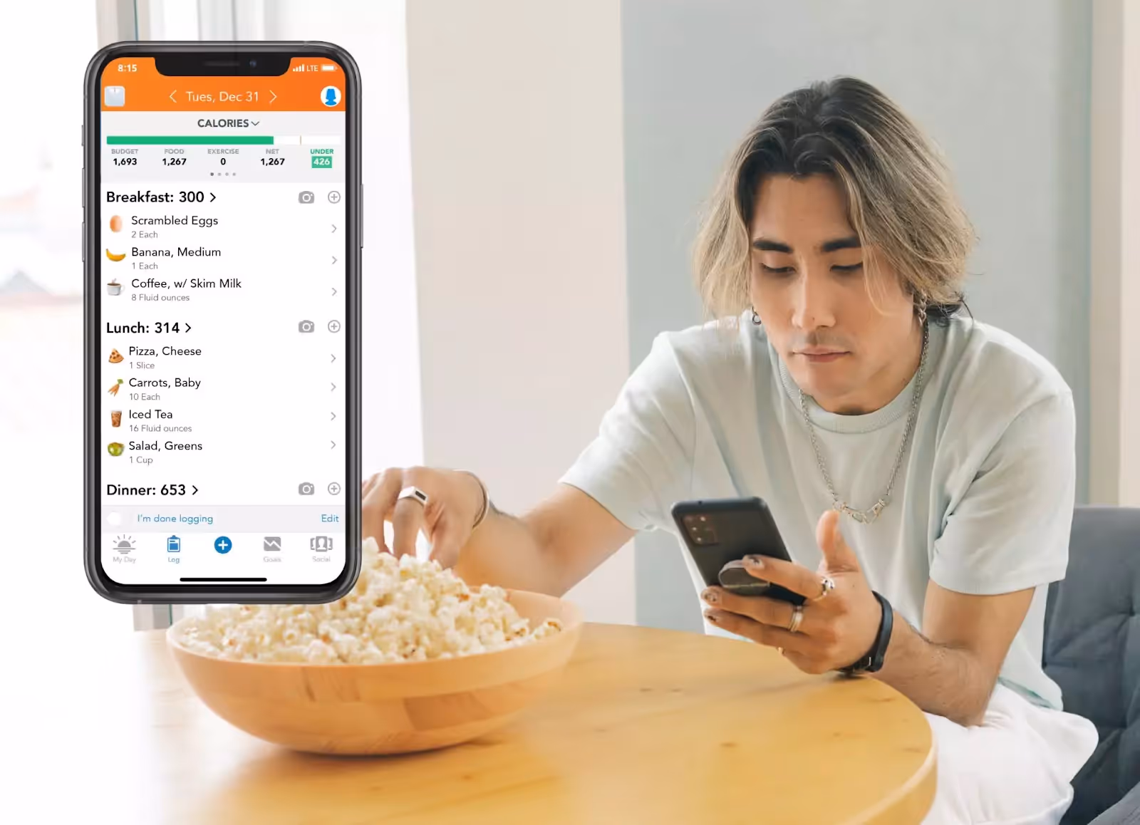 Lose It! app and a person eating popcorn 