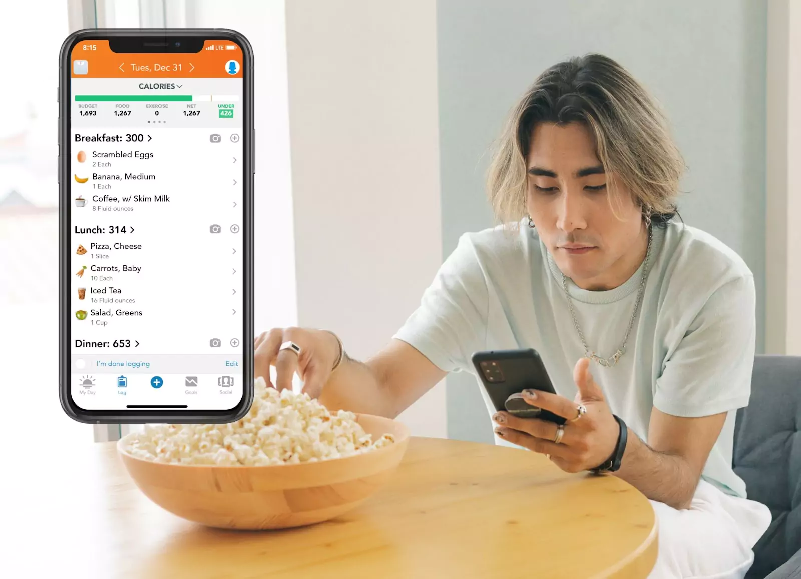 Lose It! app and a person eating popcorn 