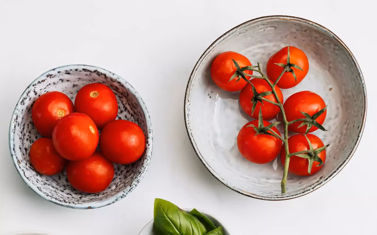 two bowls full of tomatoes