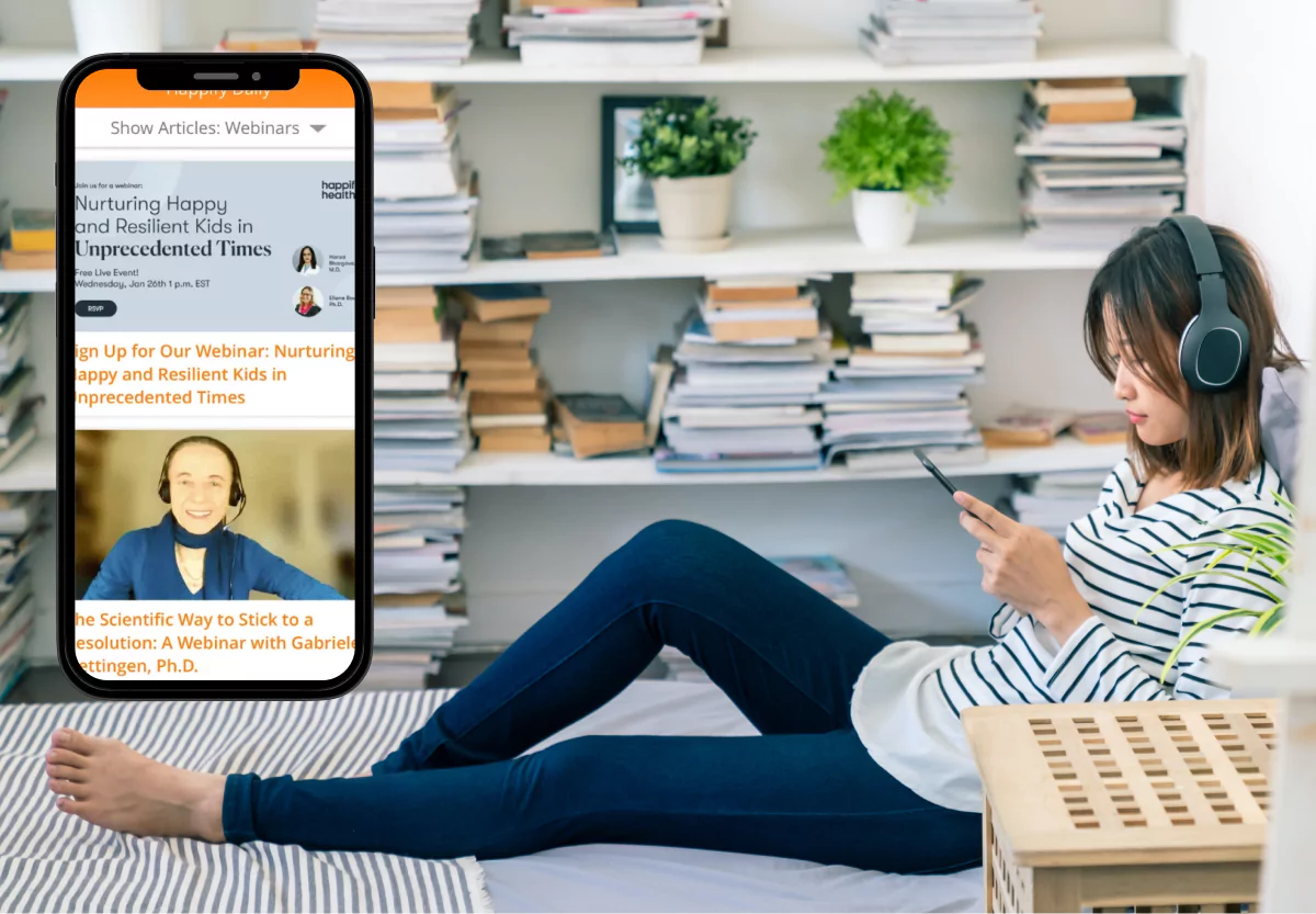 a girl looking at her phone and the happify app