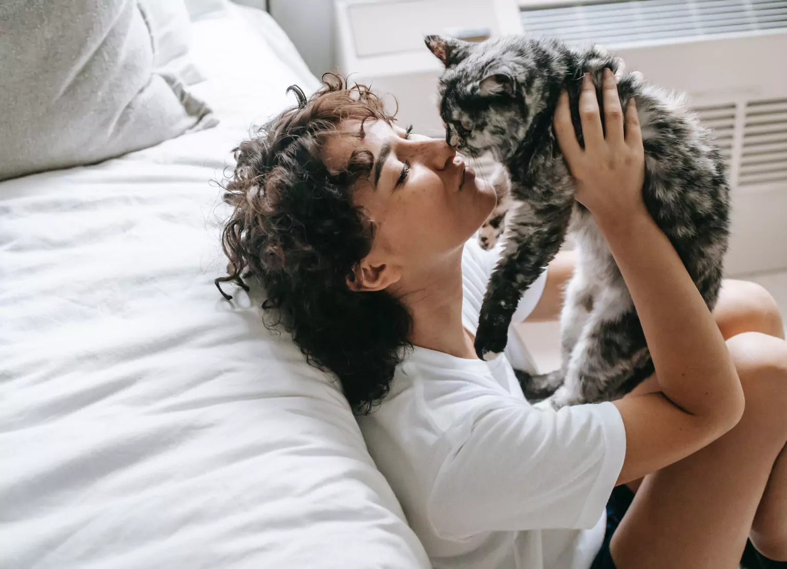 a girl kissing her cat