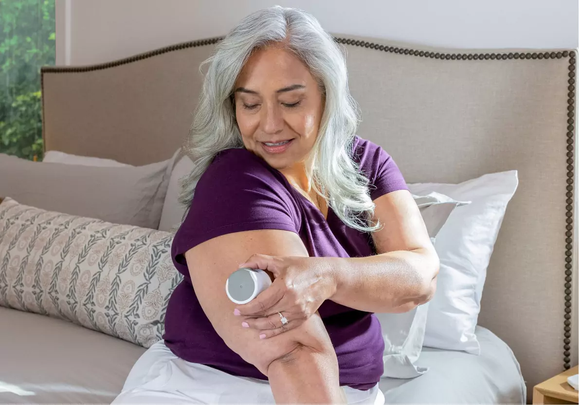 A woman applying her CGM