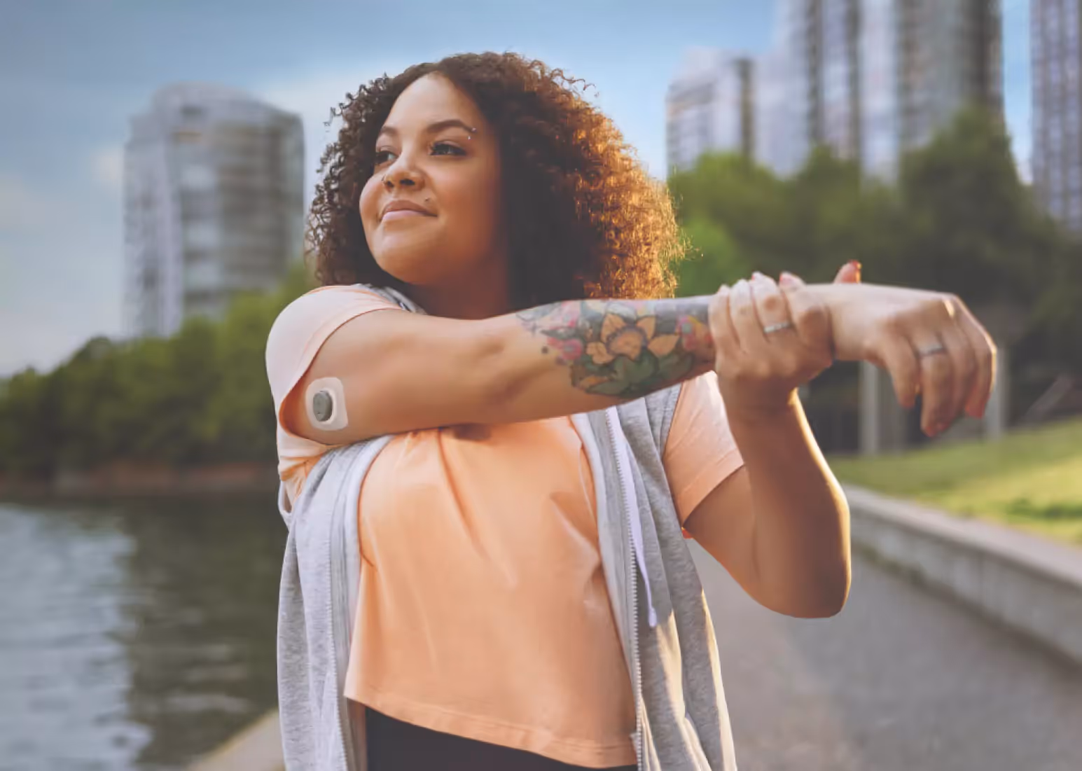 a person applying a CGM on an upper arm