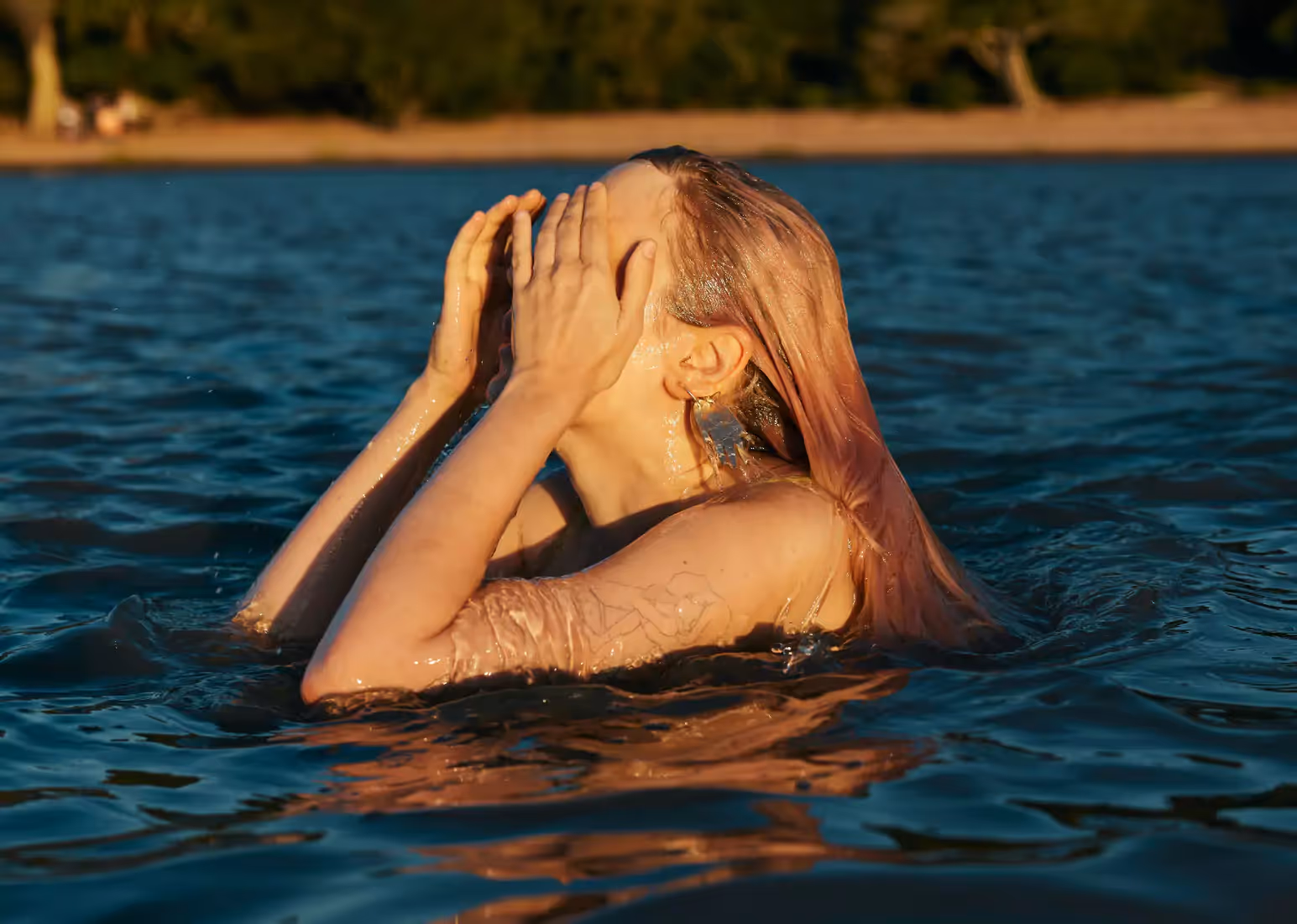 A close-up of a person against a backdrop of water