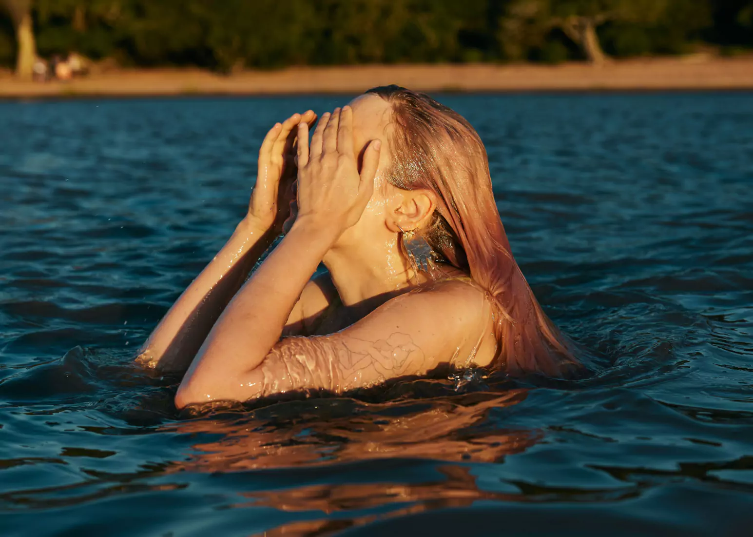 A close-up of a person against a backdrop of water
