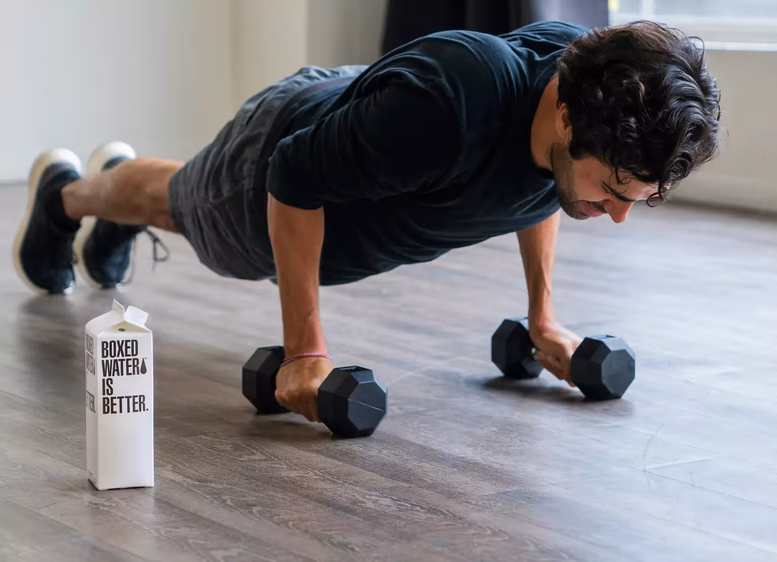 someone doing pushups with dumbbells