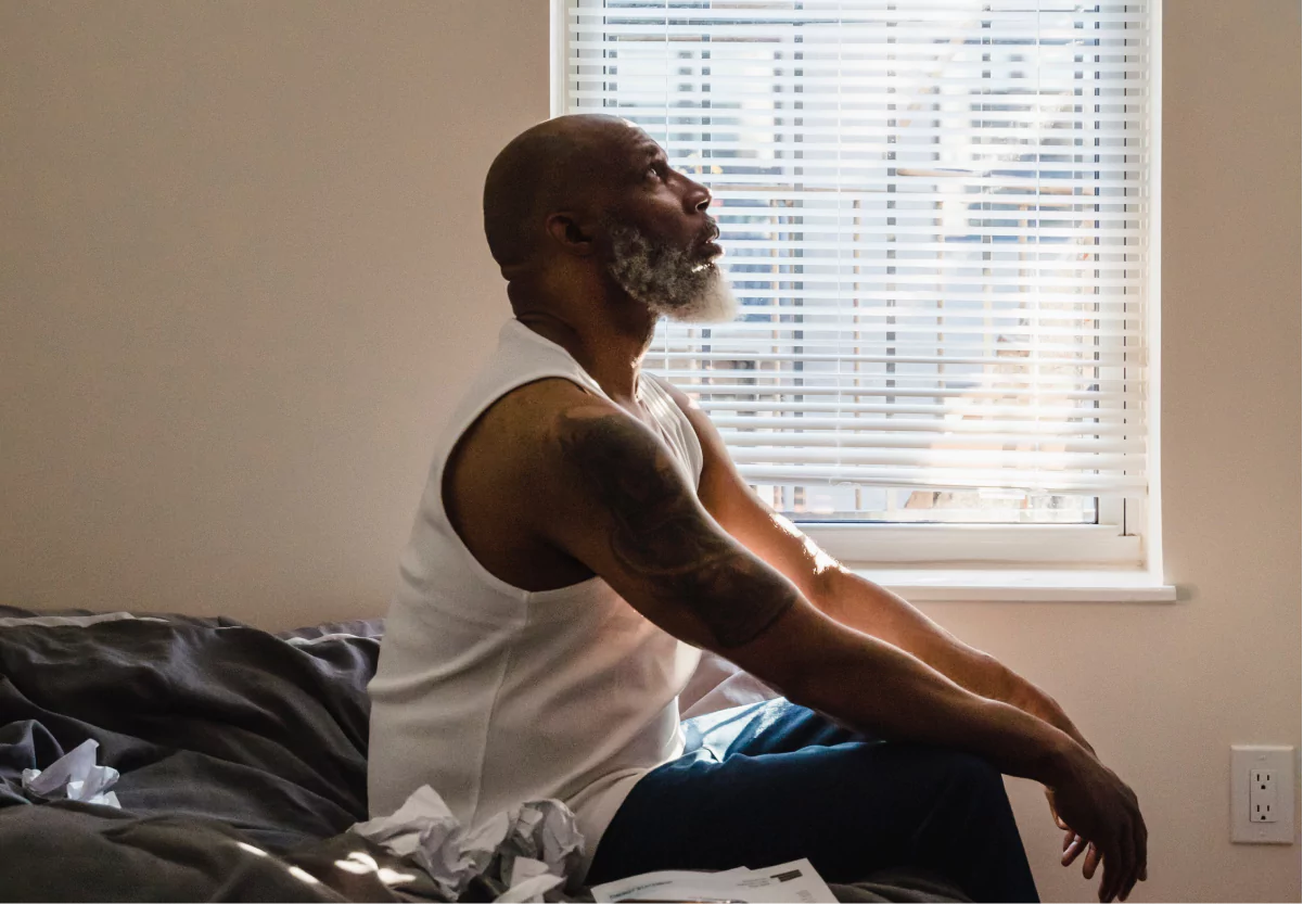 a man meditating on top of his bed