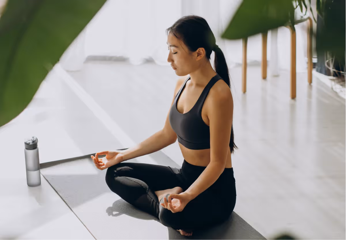 a woman meditating in workout clothes