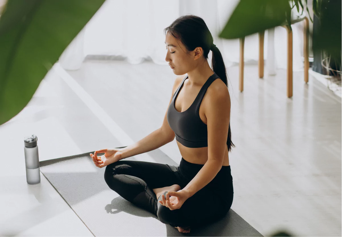 a woman meditating in workout clothes