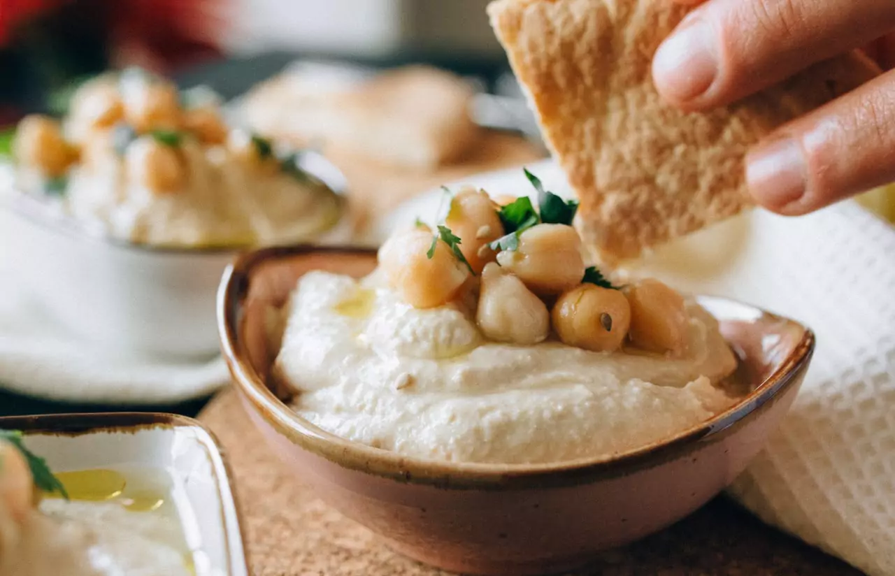 a person eating hummus