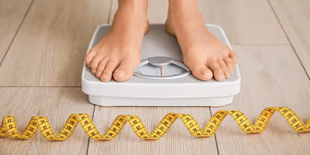 someone checking their weight on a scale