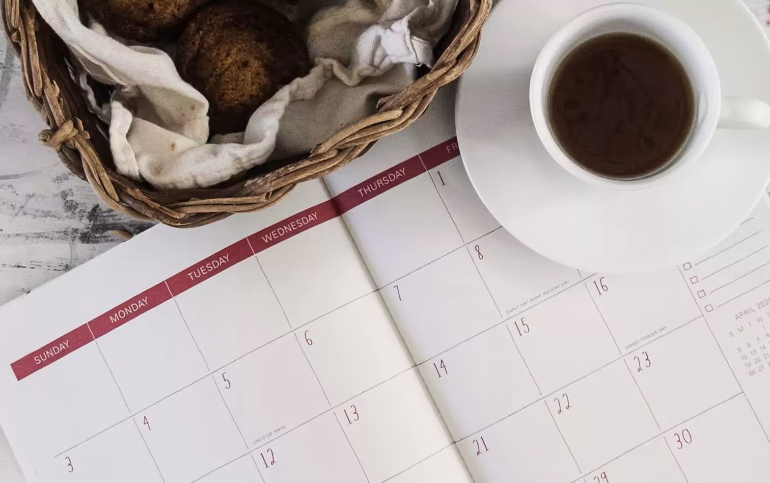 a notebook, cookies and a cup of coffee 