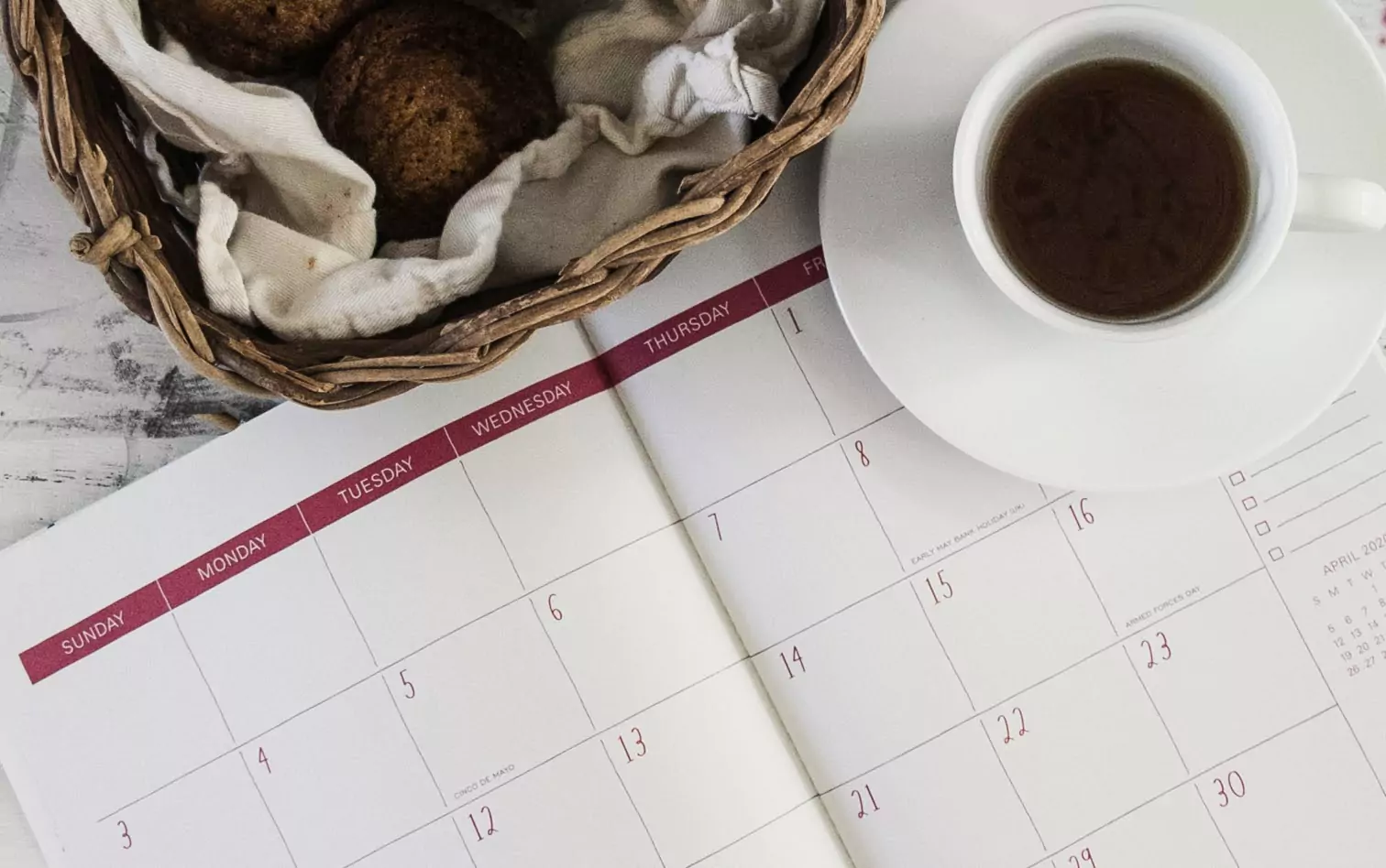 a notebook, cookies and a cup of coffee