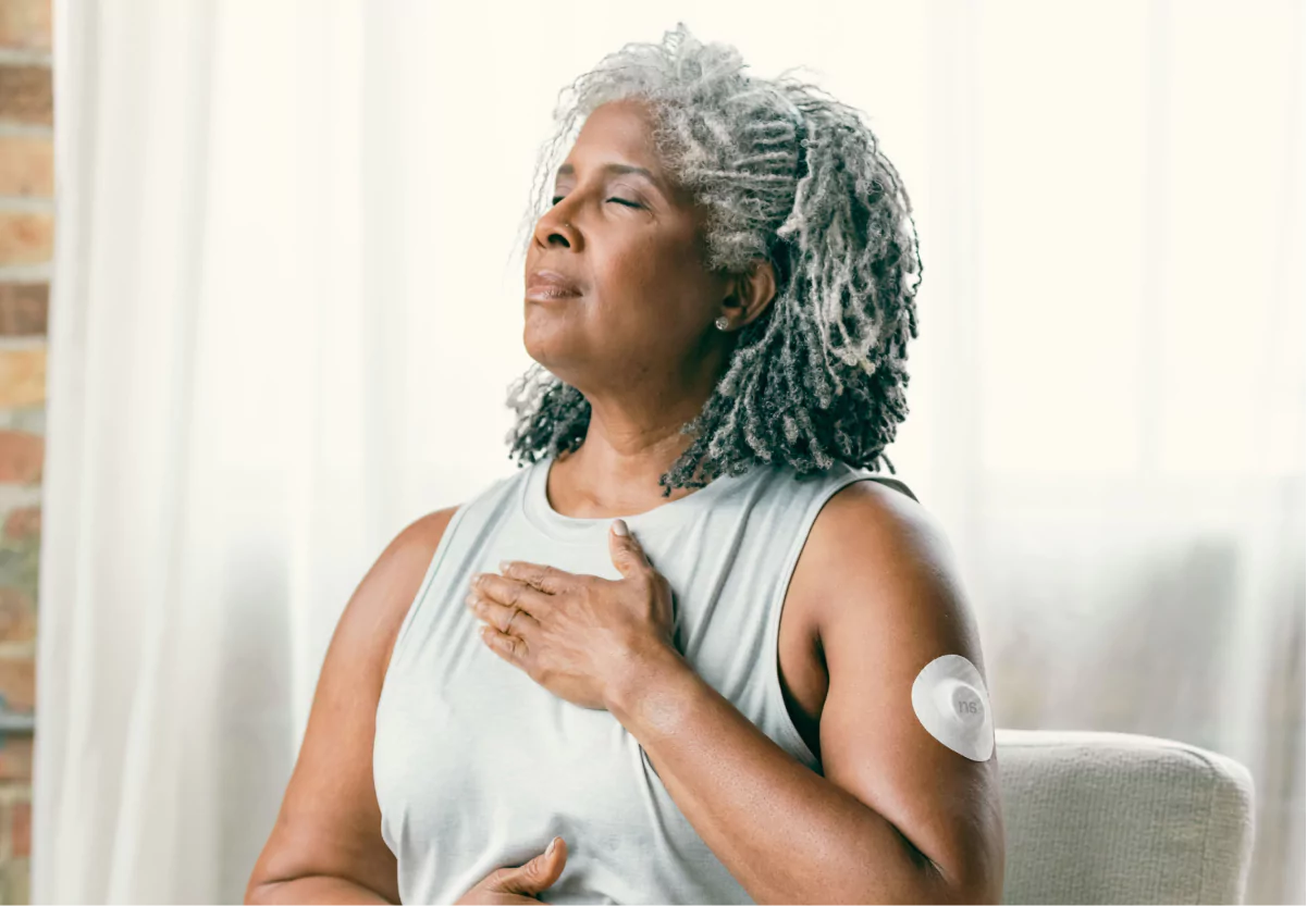 a woman with a nutrisense cgm meditating