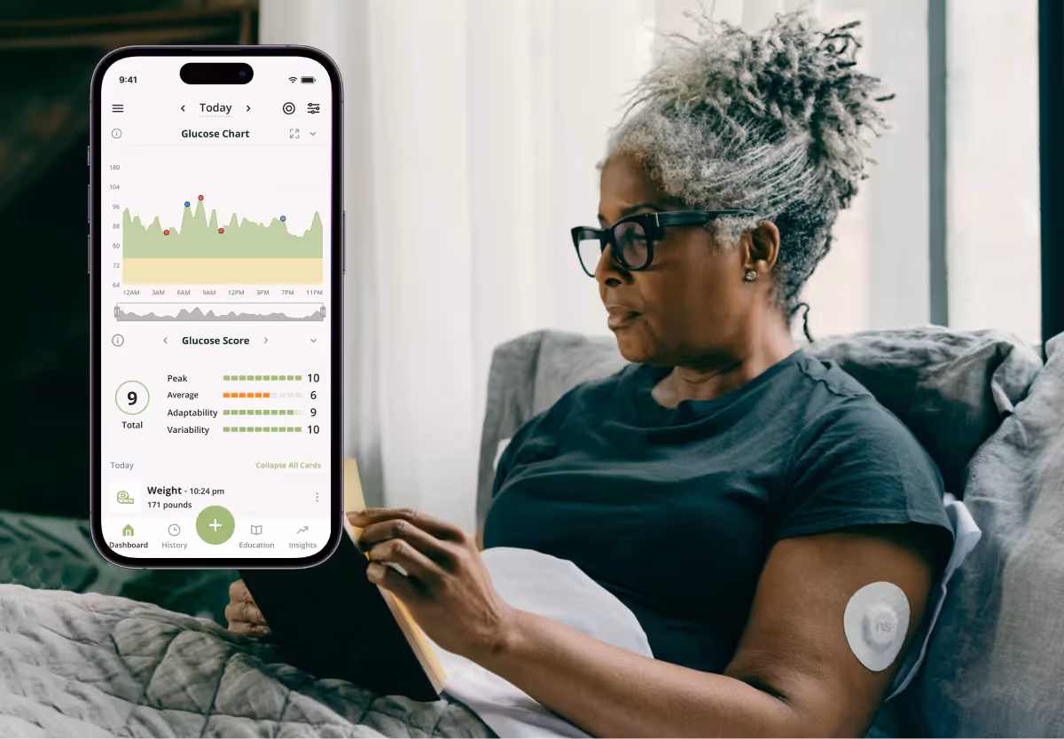 a woman looking at her glucose data in the nutrisense app