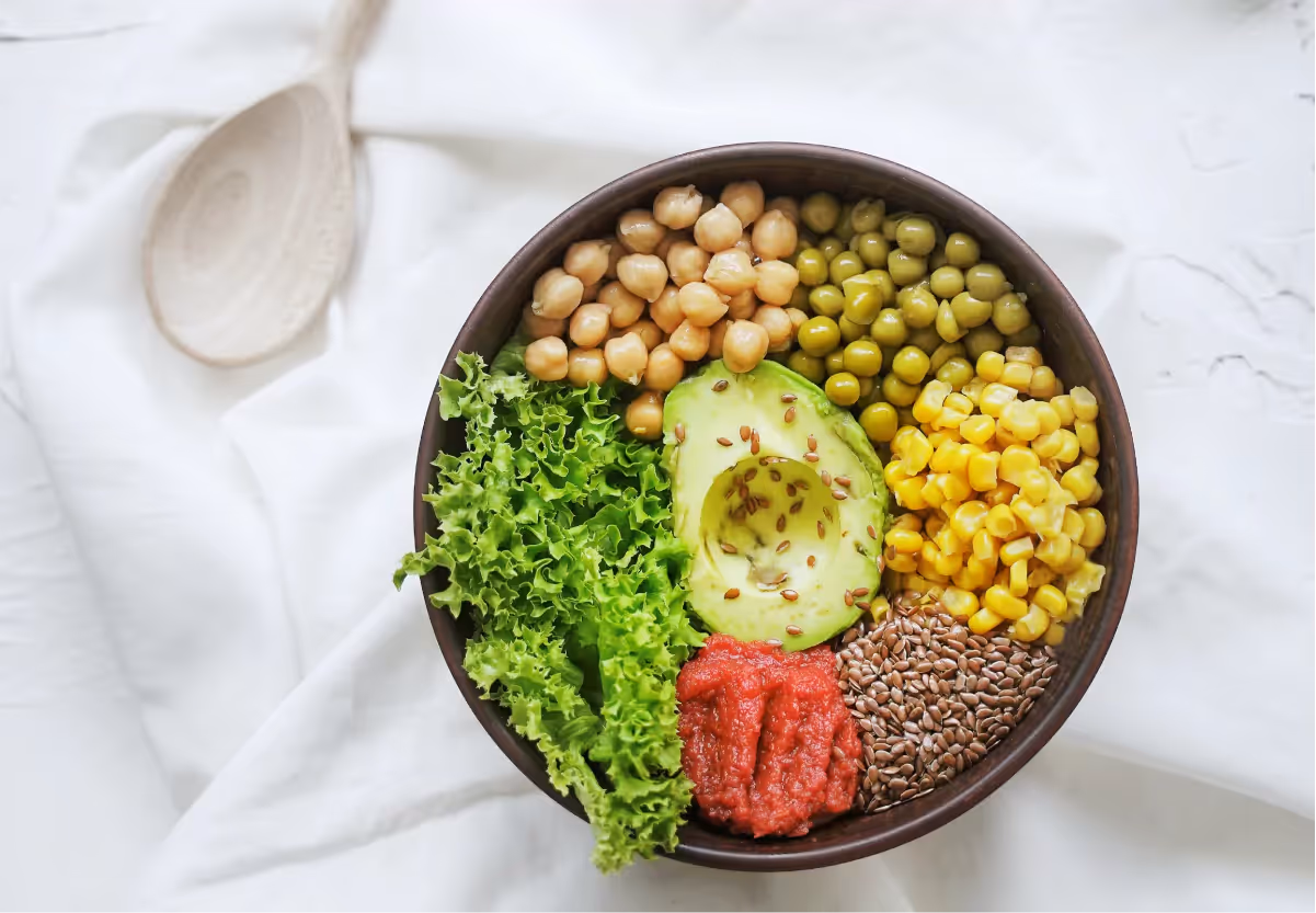 a bowl of chickpeas, avocado, and veggies